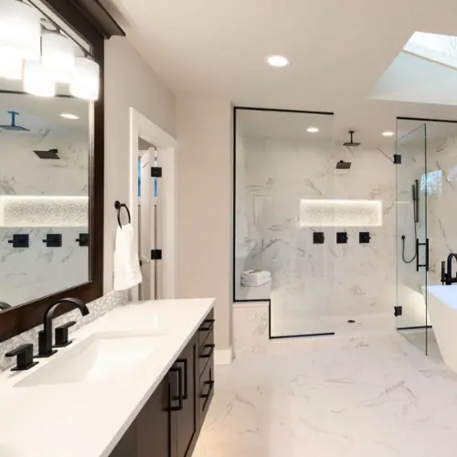 Bathroom with marble shower, frameless glass and matte black fixtures