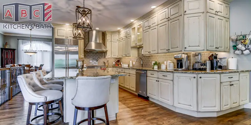 Modern Tuscan kitchen with exposed beams, island seating and cream cabinetry