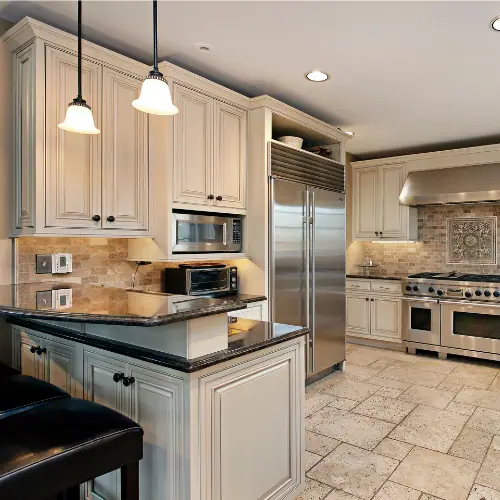 Traditional kitchen with cream cabinets, dark granite and built-in microwave